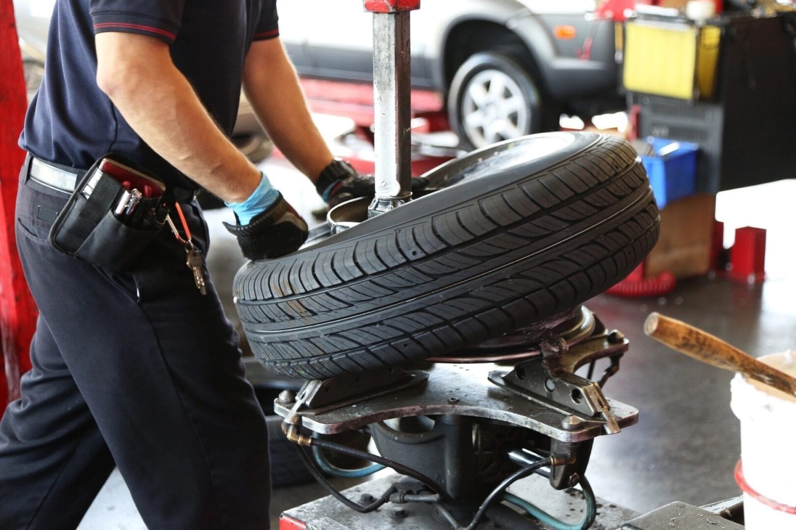 A person working on a tire in a garage.