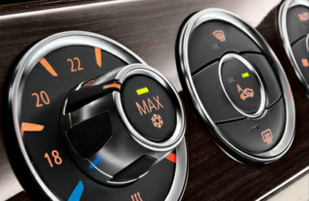 A close up of the dashboard controls on a car