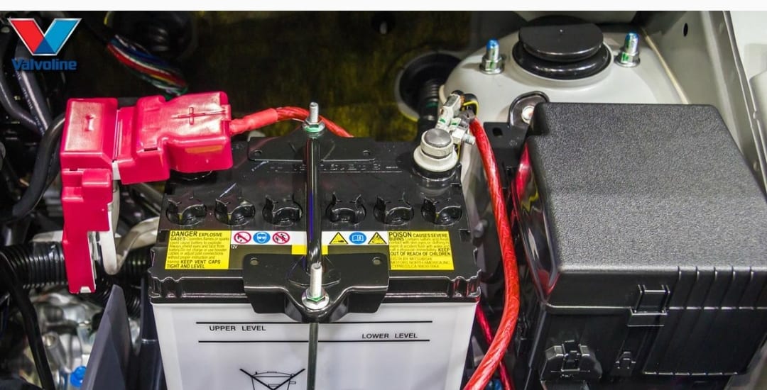 A car battery with two different types of wires attached to it.